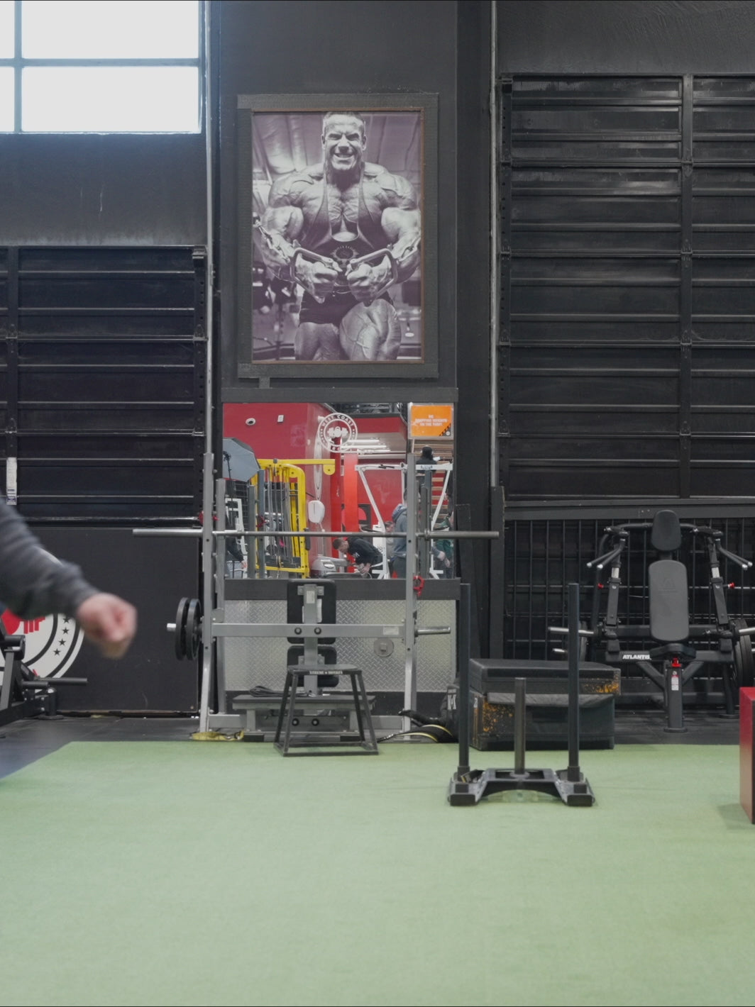 Video of Mutant athlete Dana Baker posing in the gym, wearing the Grey Mutant Patched Zip-Up Gym Hoodie.